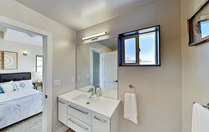 Master bathroom with vanity, mirror, and window