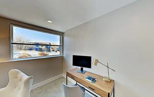 Bottom level office desk with computer and chair