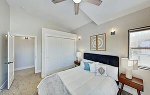 Master bedroom with queen bed and large closet