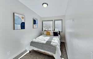 Guest bedroom with queen bed and chevron throw blanket