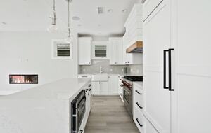 Home exchange in Newport Beach CA, elongated all-white kitchen