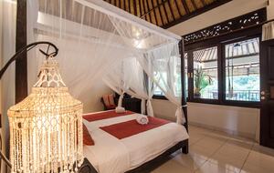 Home exchange in Ubud, Bali, second bedroom canopy bed facing window