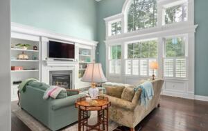 Spacious sun-filled living room with TV