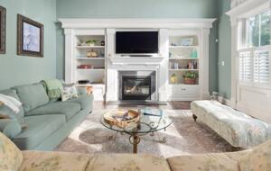 Spacious sun-filled living room with TV