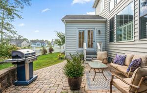 Backyard patio with sitting area and grill