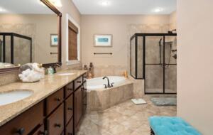Elegant master bathroom with tile floors and walk in shower