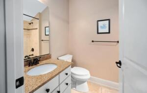 Secondary bathroom with tile floors and granite countertop