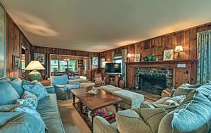 Main living room with stone fireplace and smart TV