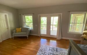 Home Exchange in Winchester, TN master bedroom seating area with deck
