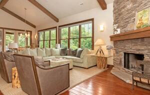 Open living room with stone fireplace