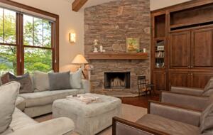 Open living room with stone fireplace