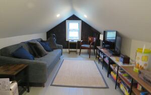 Home Exchange in Hillsdale, NY play room with seating, tv, and toys