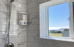 Full sized shower upstairs above garage with window view..