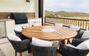 Outdoor pool area with grill and dining table