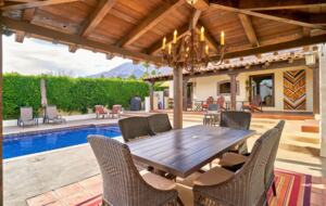 Home Exchange in Palm Springs, CA dining table under the pergola
