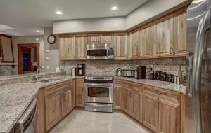 Kitchen with granite countertops and cherry cabinetry