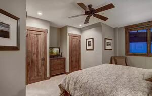 Bedroom 1 with ensuite bathroom and view of slope