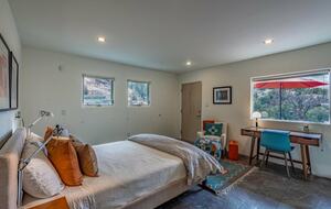 Guest bedroom with desk. Private patio.