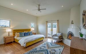 Master bedroom with fireplace and private patio