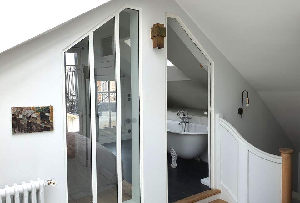 view into the master bedroom upstairs, with bath tub