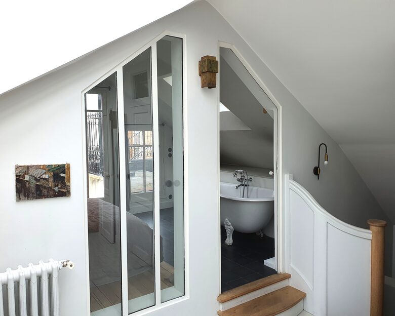 view into the master bedroom upstairs, with bath tub