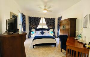 Blue Bedroom w. Queen Bed, Writing Desk, Closet, Chest, TV