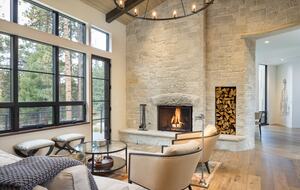 Living room with vaulted ceilings and stone wall fireplace