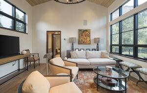 Living room with cliff views and large TV monitor.