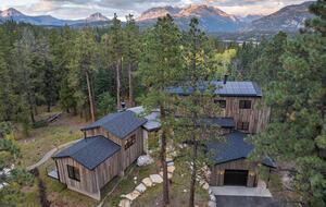 Aerial picture of front of home with mountains in the distance.