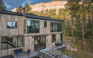 Exterior view of custom Durango Mountain Home and cliffs.