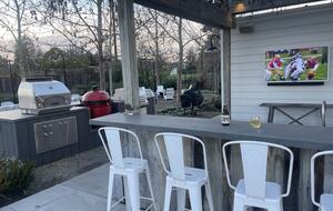 The first of 2 outdoor bars, with TV, fridge, and BBQ area.