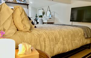 Detached bedroom above garage with workspace.