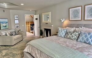 CA king bed. Lighter bedding is used during warmer months.