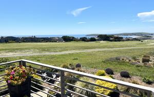 Looking down from primary bedroom balcony down onto patio.
