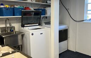 Laundry area inside converted garage for guest use.