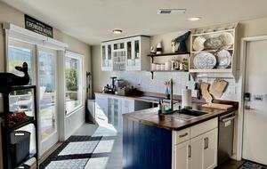 Kitchen with side yard and hot tub in background.