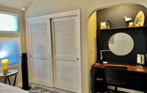 Closet and desk area downstairs bedroom.