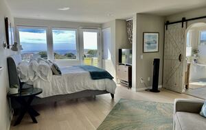 Primary bedroom with CA king bed views of fairway & ocean.