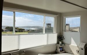 Panoramic water views with tub and walk in shower.