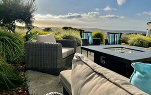 Fire pit table with fairway and ocean views beyond.