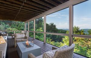 Downstairs screened in deck with firepit and amble seating