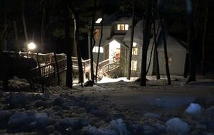 A winter view from the road looking down at the home.