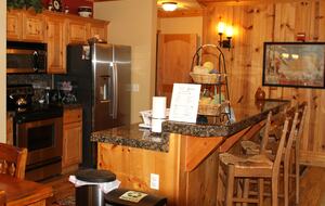 Full kitchen with stainless steel appliances.