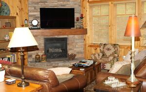 Great room with gas fireplace and 55in TV.