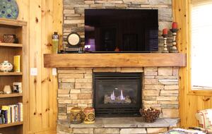 Gas fireplace and 55in smart TV with cable.