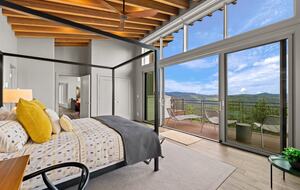 Primary bedroom w/private deck overlooking Deer Creek Valley