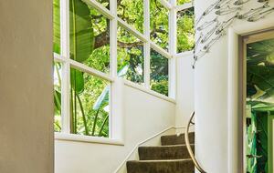 stairway 2nd floor to 3rd floor with glimpse of 1/2 bath