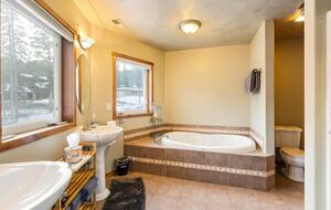 Master bedroom bathroom includes two sinks, a shower and a bathtub