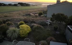 View from primary bedroom balcony at sunset.