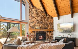 Vaulted ceilings, fireplace, and mountain views